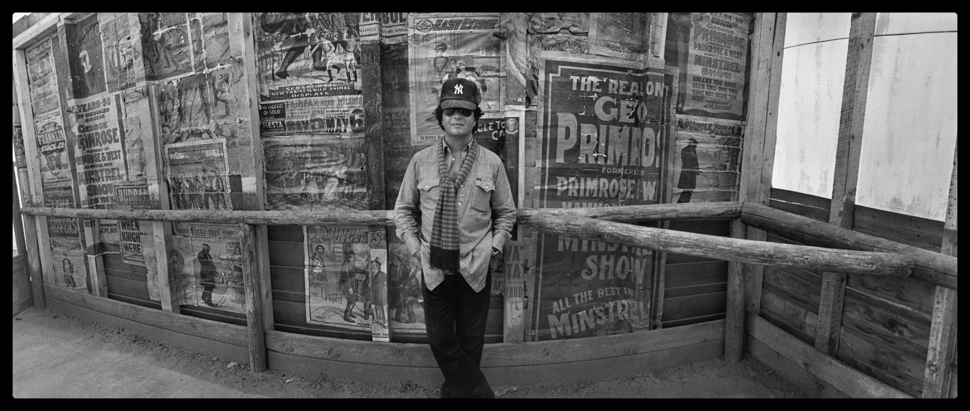 Photo of man standing in a movie set, looking at the photographer.